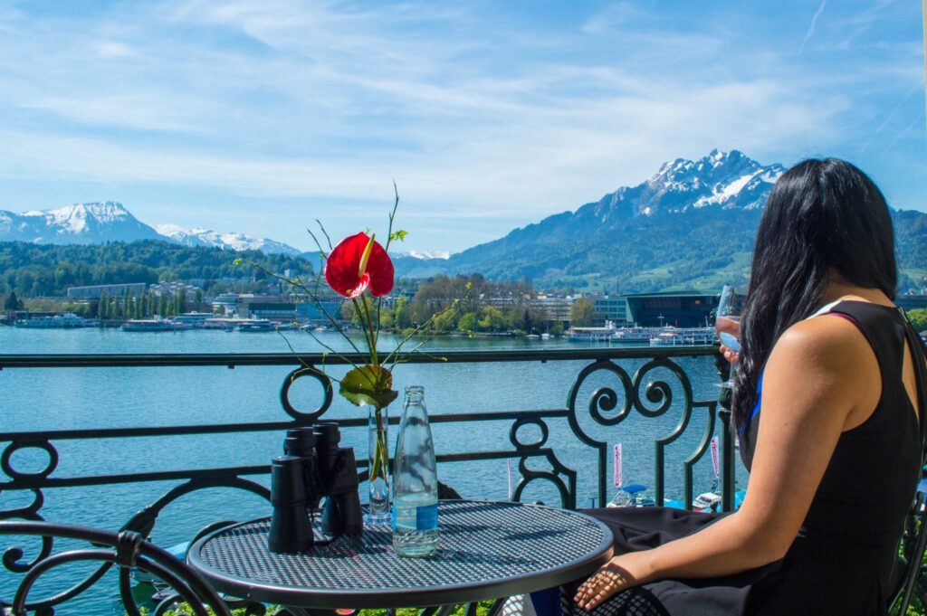 Traveller sipping wine at the Grand Hotel National in Lucerne