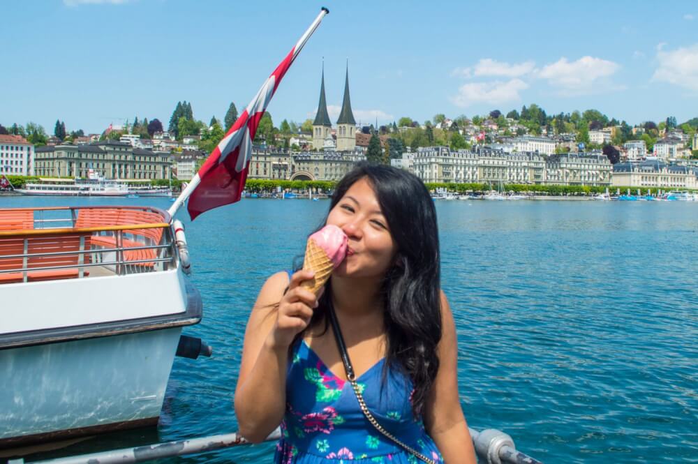 Travel blogger eating ice cream by Lake Lucerne