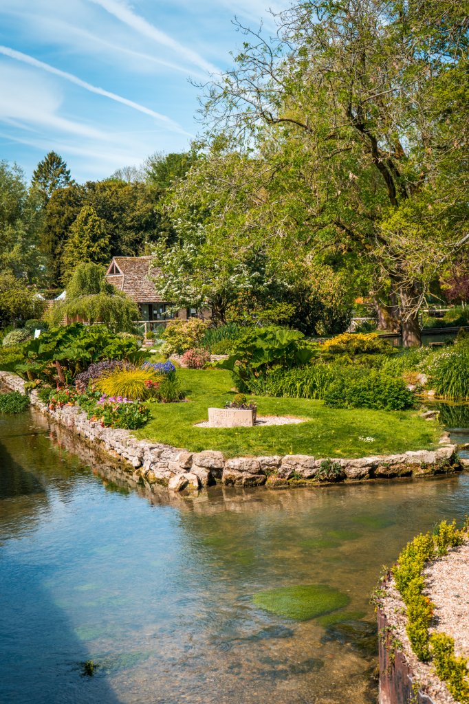 A peaceful garden in Bibury, England along the water.