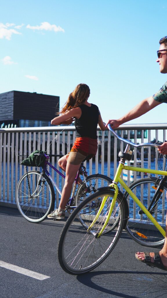 Fit couple riding bikes in Copenhagen