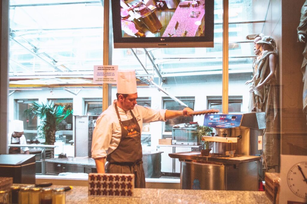 Chocolatier giving a chocolate demonstration at Chocolart in Bruges, Belgium