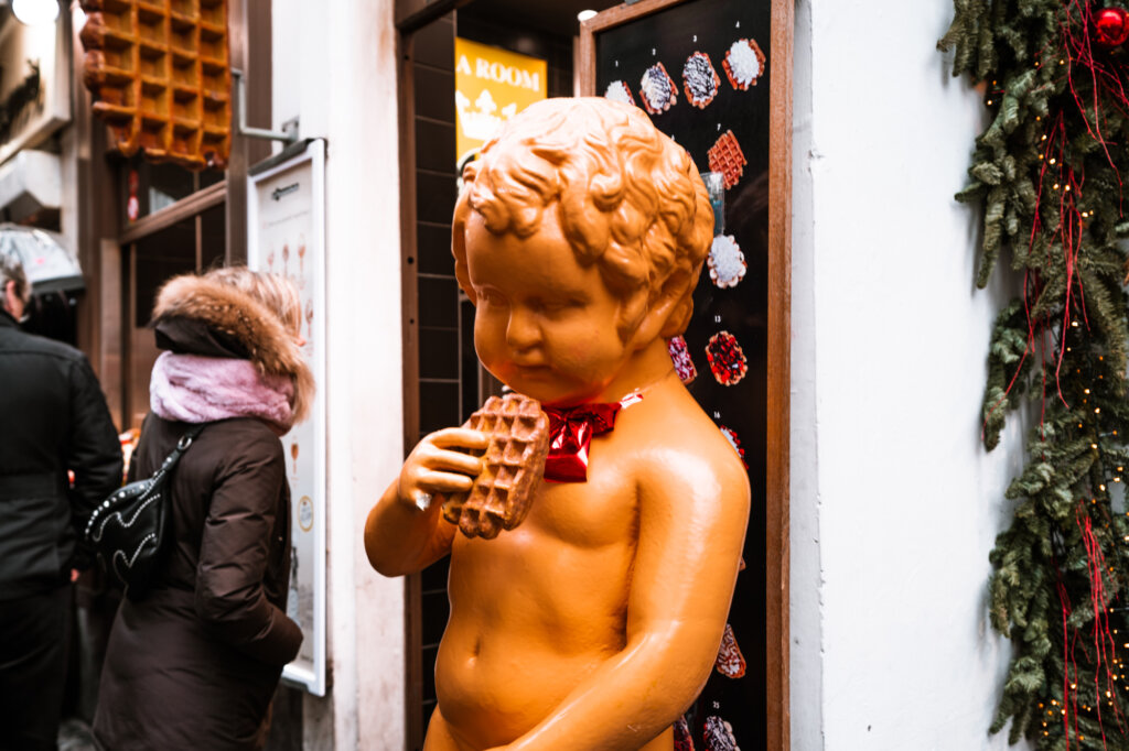 Mannekin Pis statue in Brussels eating a waffle