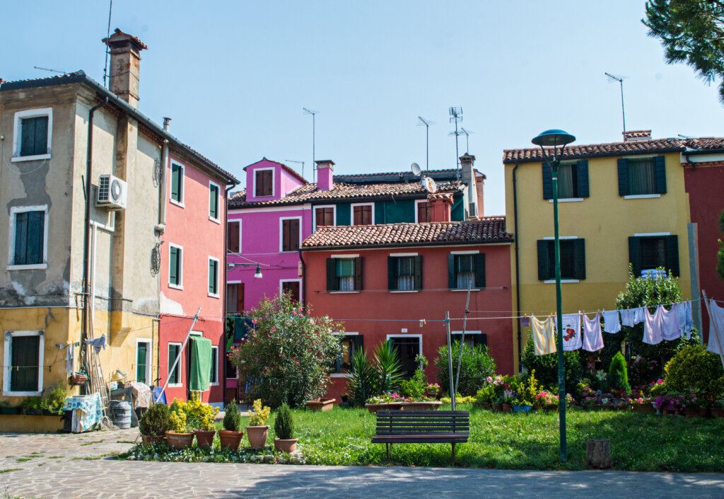 Rainbow houses with hanging laundry in Burano, Italy