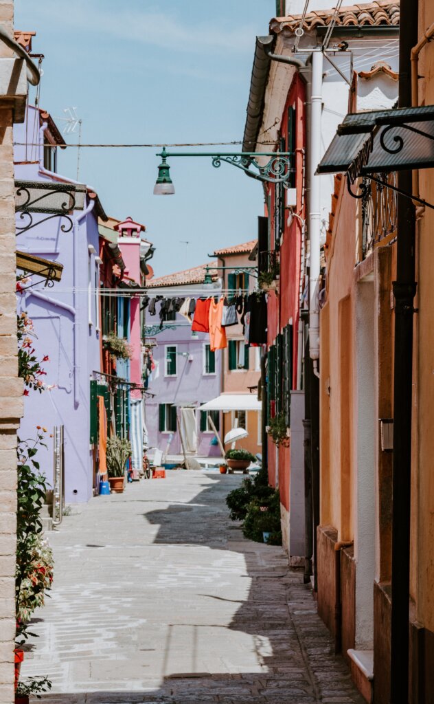 Quiet back street with laundry hanging in Burano, Italy