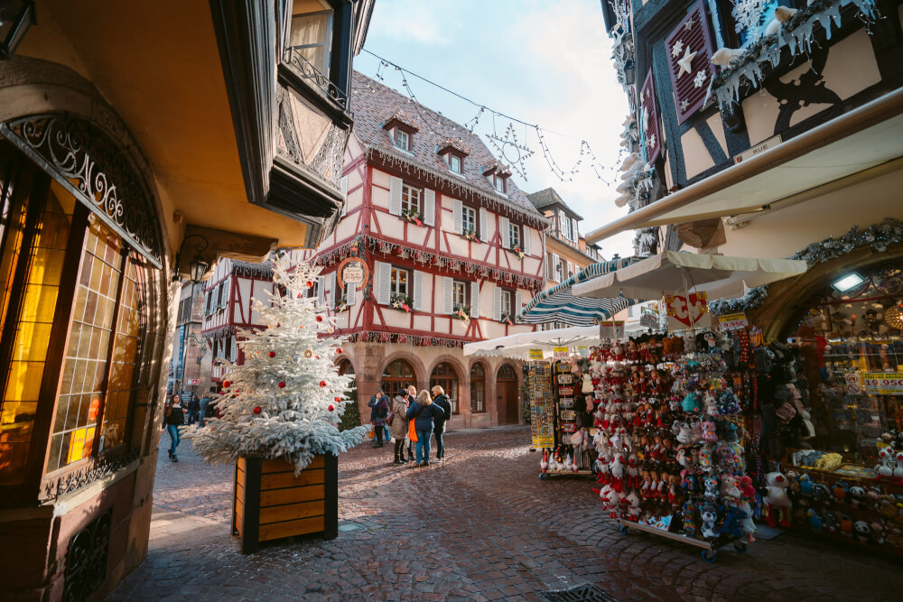 Souvenir shops on a busy street in Colmar France