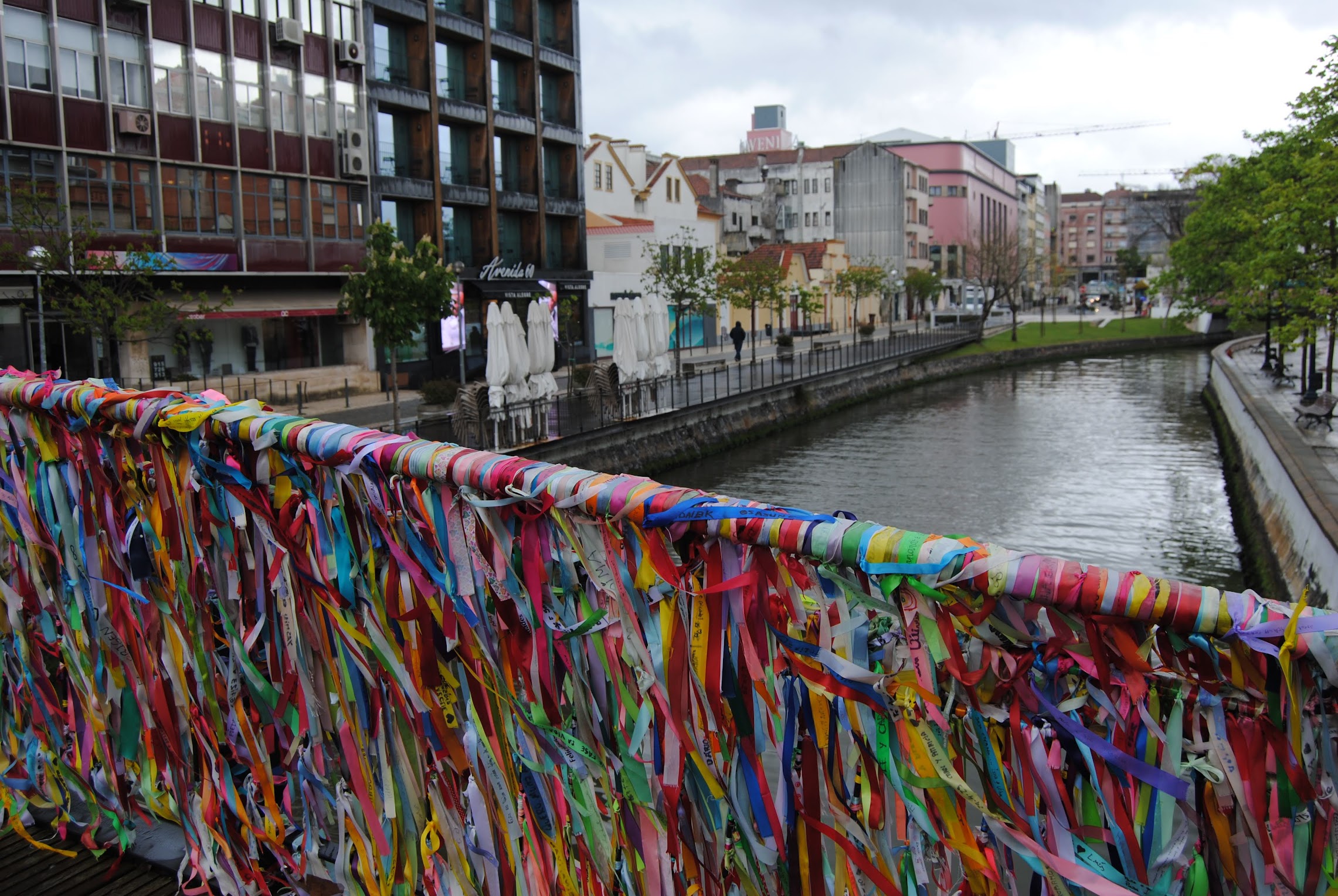 A bridge over a canal with colorful ribbons