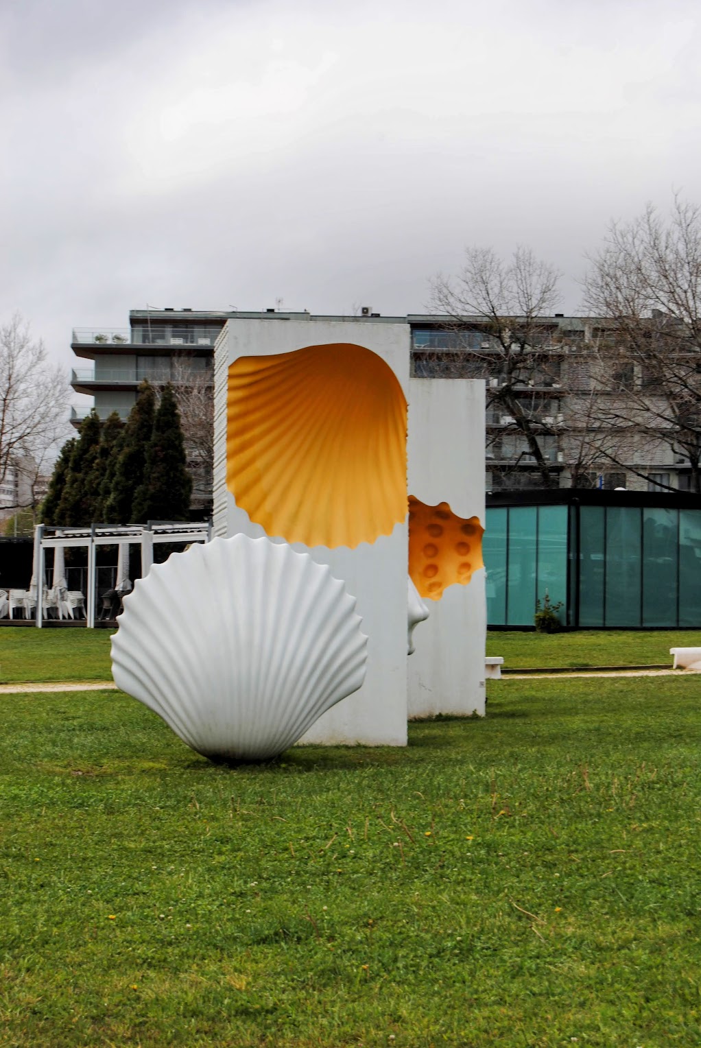 A white and yellow statue of a shell-shaped pastry