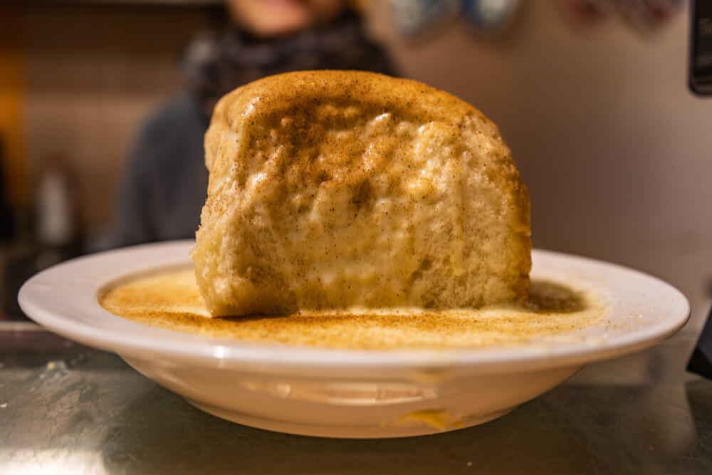 Dampfnudel, a Bavarian dessert in vanilla sauce at Oktoberfest in Munich, Germany.