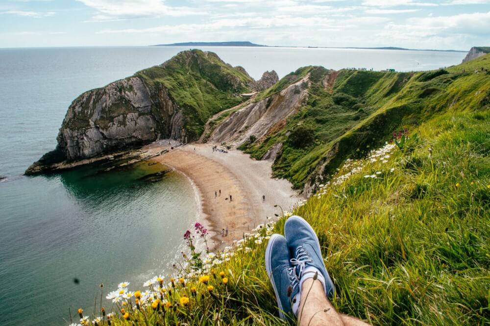 A traveler lounging along the Jurassic Coast in Dorset, England.