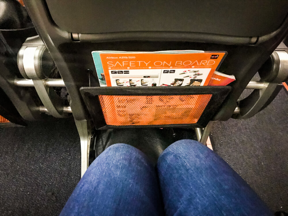 Passenger showing amount of leg room on an easyJet flight