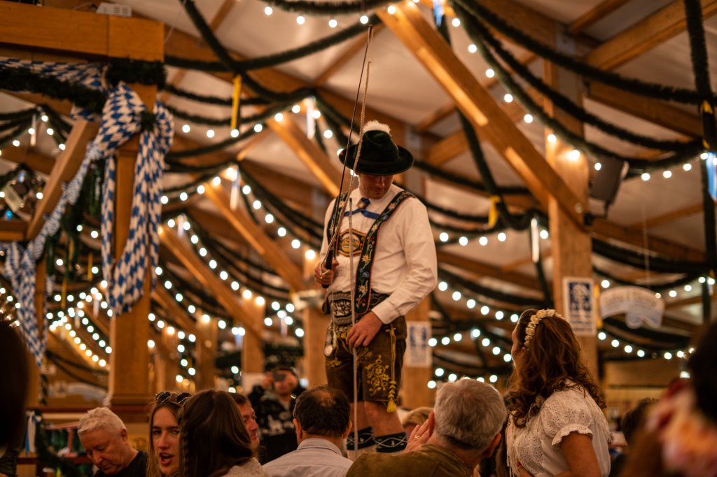 Man wearing traditional Bavarian attire at Oktoberfest in Munich, Germany