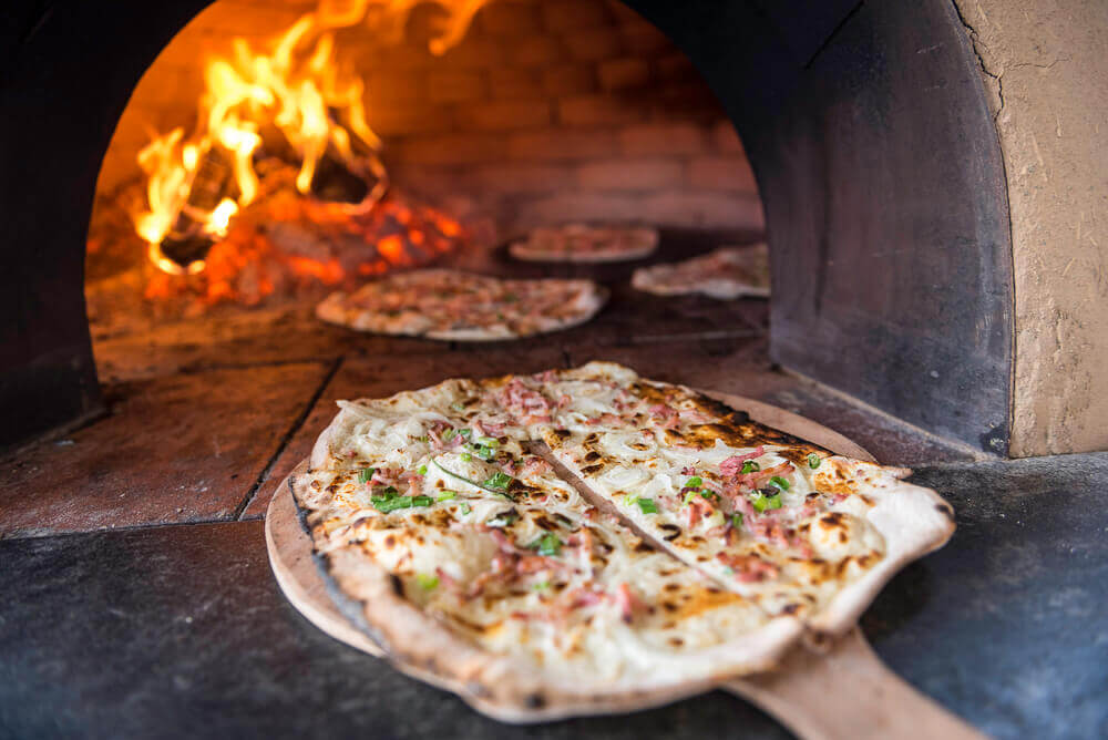 Alsatian Flammkuchen going into the oven.