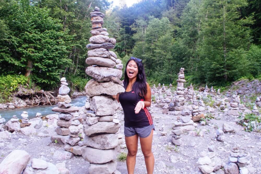 Woman posing with rock sculptures near Partnachklamm