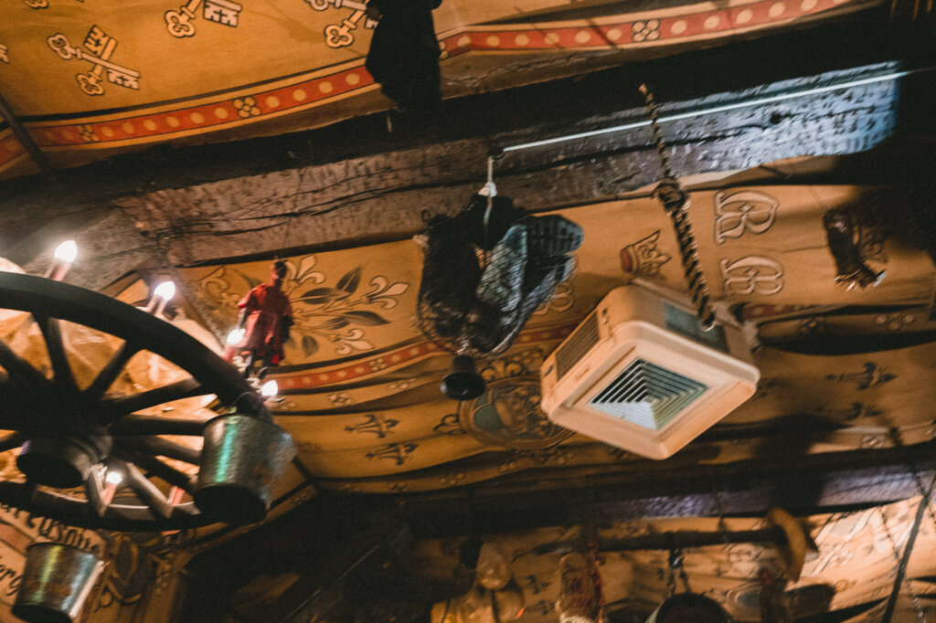 Shoes dangling in a basket above a bar in Ghent