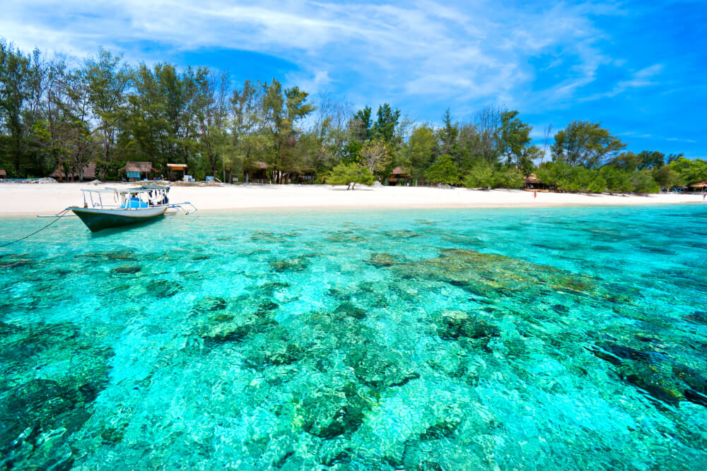 Boat on a beach with turquoise water in Gili Meno, Indonesia