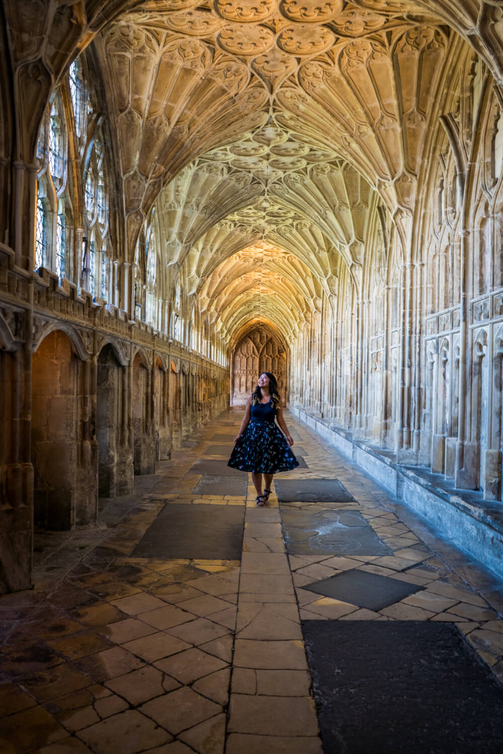 Christina Guan standing in the cloister of Gloucester Cathedral in Gloucester, Gloucestershire, England