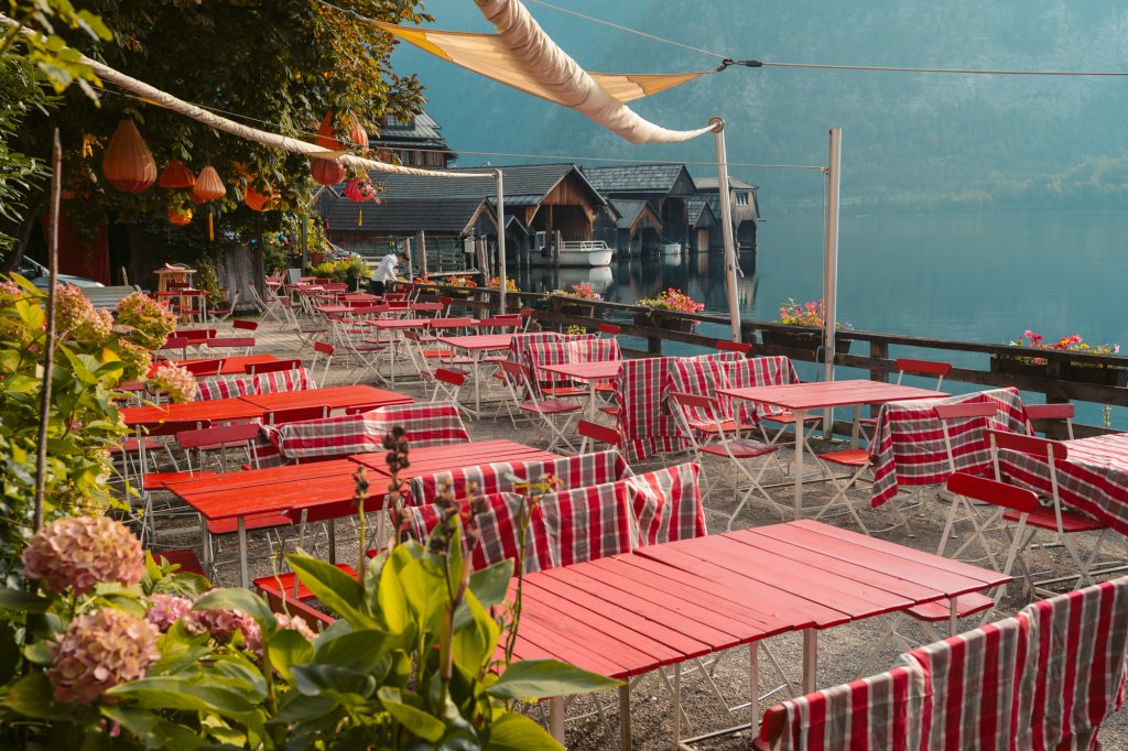 Pretty seating area along the water in Hallstatt, Austria belonging to the Bräugasthof.