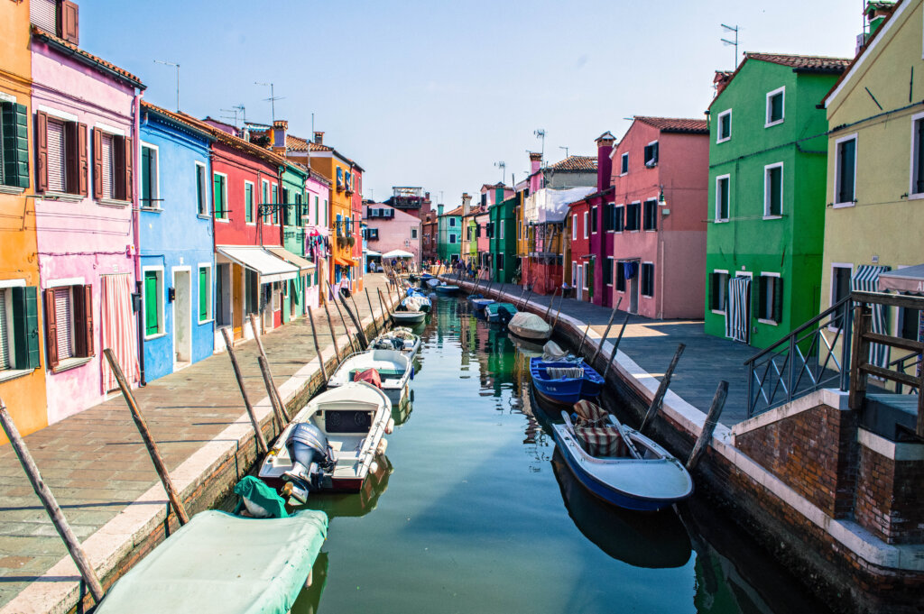 Rainbow houses lining a canal in Burano, Italy