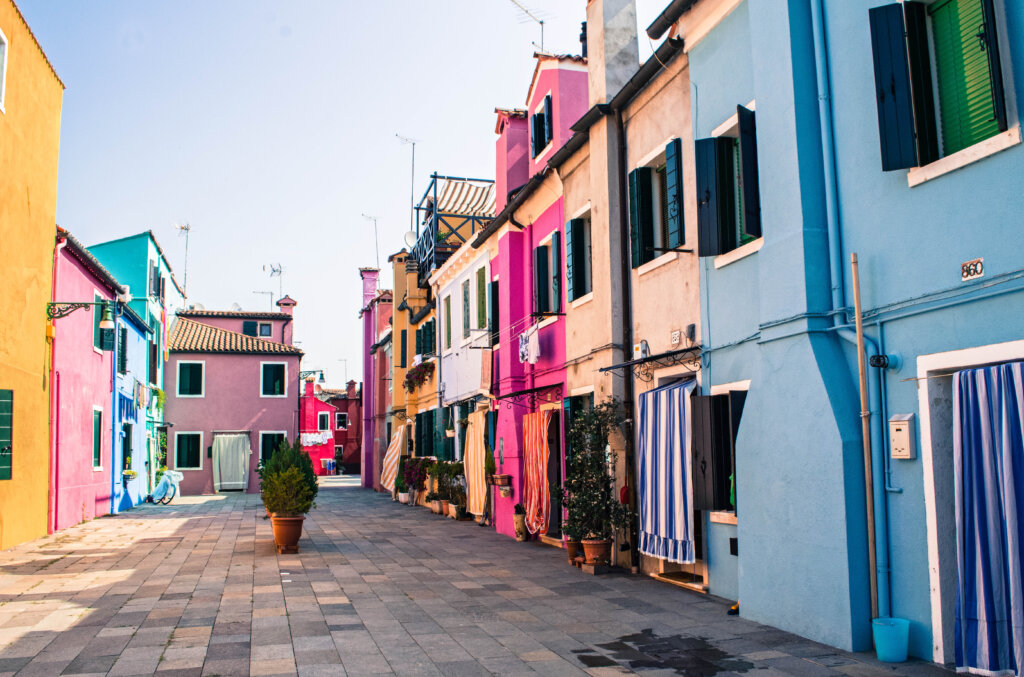 Colourful street lined with rainbow houses in Burano, Italy