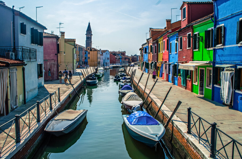 Canal lined with rainbow houses in Burano, Italy