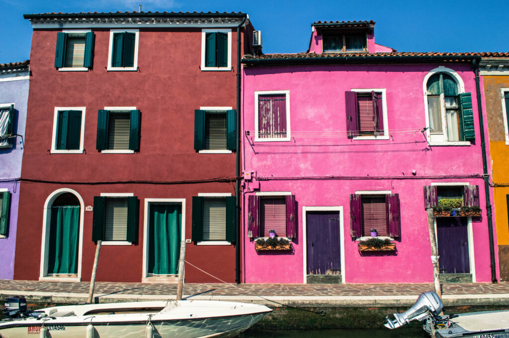 Colourful red and pink houses in Burano, Italy