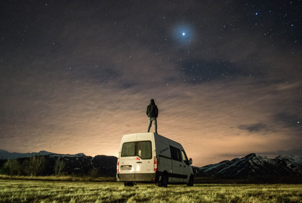 Man standing on a van in Iceland