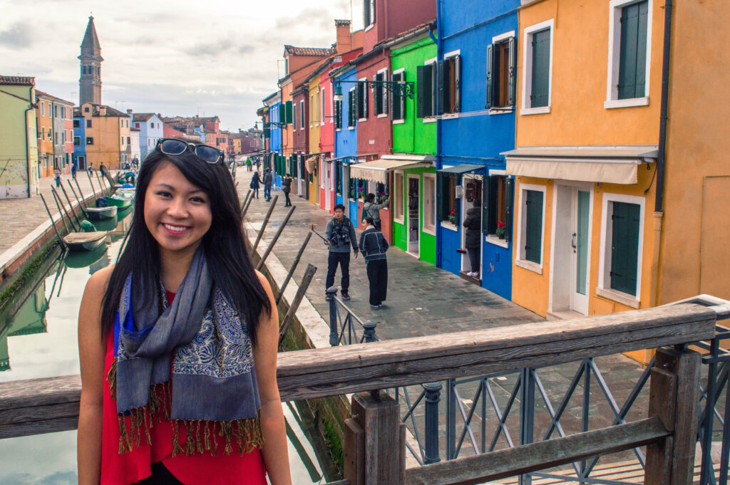 Girl posing on bridge in Burano, Italy