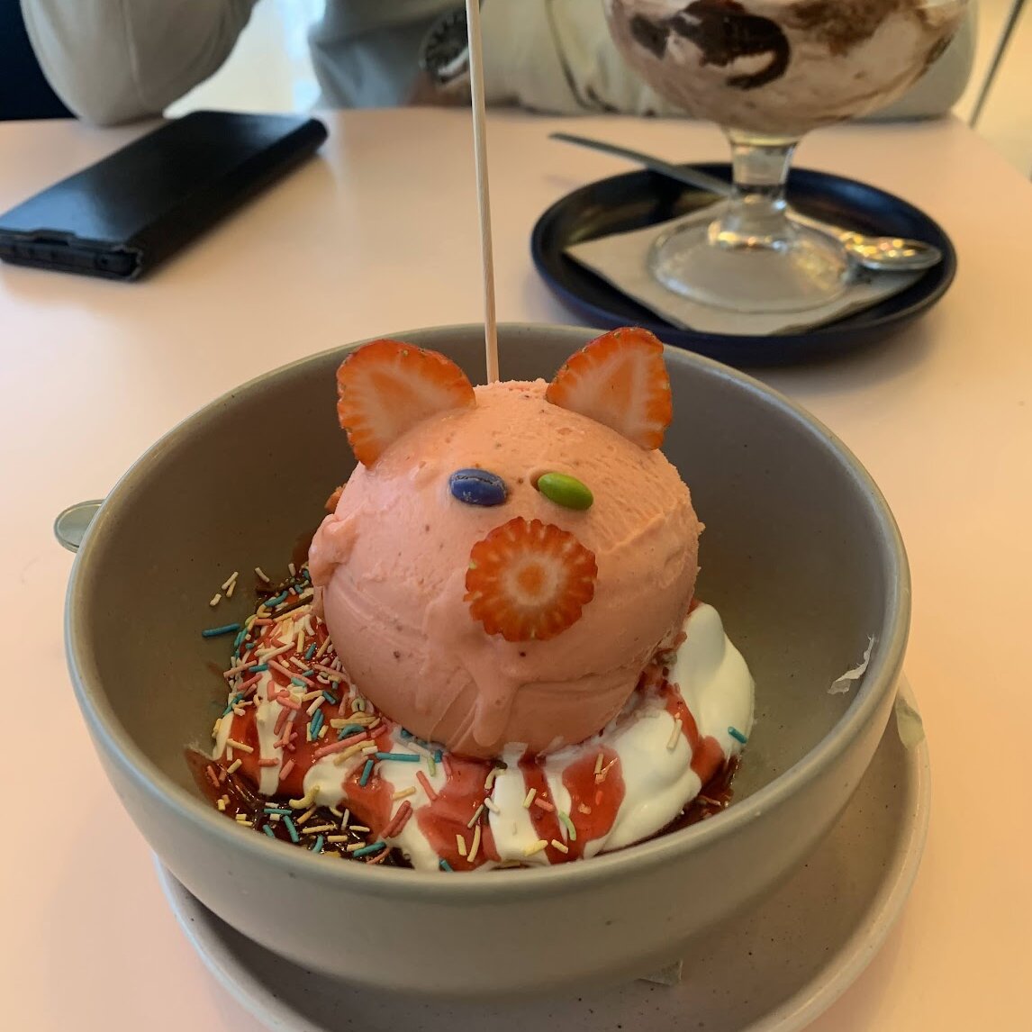 An ice cream sundae shaped like a pink pig