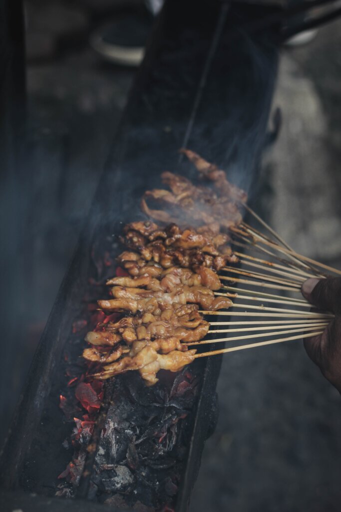 Chicken skewers being grilled in Indonesia