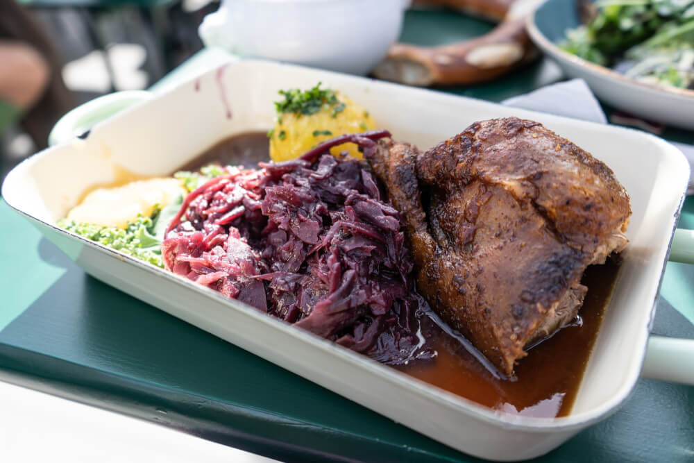 A plate of roast duck with red cabbage and potato dumpling at Oktoberfest in Munich, Germany.