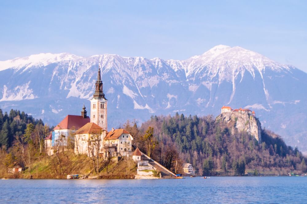 How to get the BEST view of Lake Bled, Slovenia at sunrise. This guide shows you how to hike to this gorgeous viewpoint of Lake Bled and gives you practical advice on how to find the trail head and more!