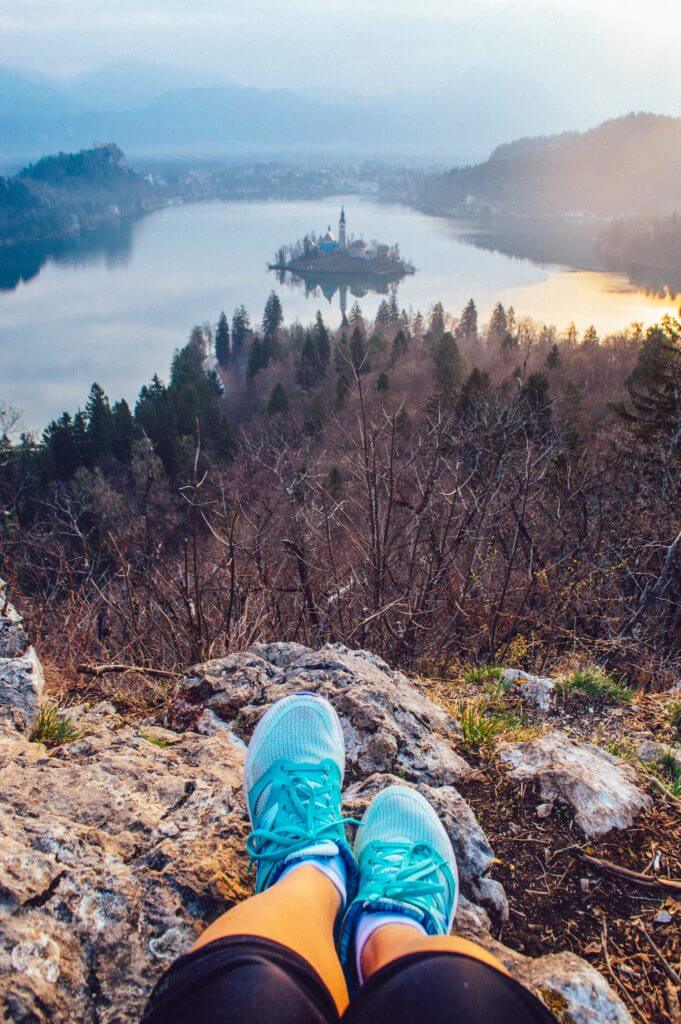 How to get the BEST view of Lake Bled, Slovenia at sunrise. This guide shows you how to hike to this gorgeous viewpoint of Lake Bled and gives you practical advice on how to find the trail head and more!