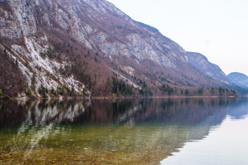 Lake Bohinj, Slovenia is one of THE most magical and serene lakes in the whole world. Here's an easy guide on how to get the best views of this massive lake (Slovenia's largest), including a map on how to get to the best spot for photos.