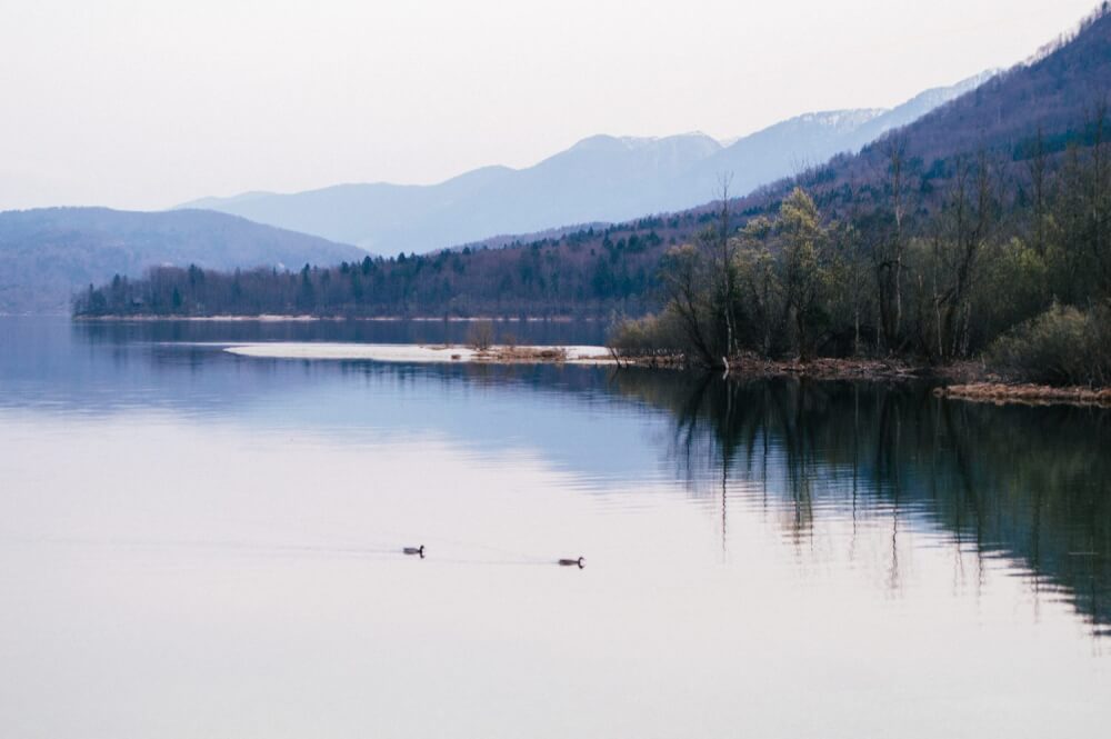 Lake Bohinj, Slovenia is one of THE most magical and serene lakes in the whole world. Here's an easy guide on how to get the best views of this massive lake (Slovenia's largest), including a map on how to get to the best spot for photos.