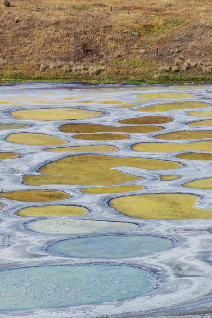 Polka dotted lake with blue and yellow spots in Osoyoos, BC, Canada