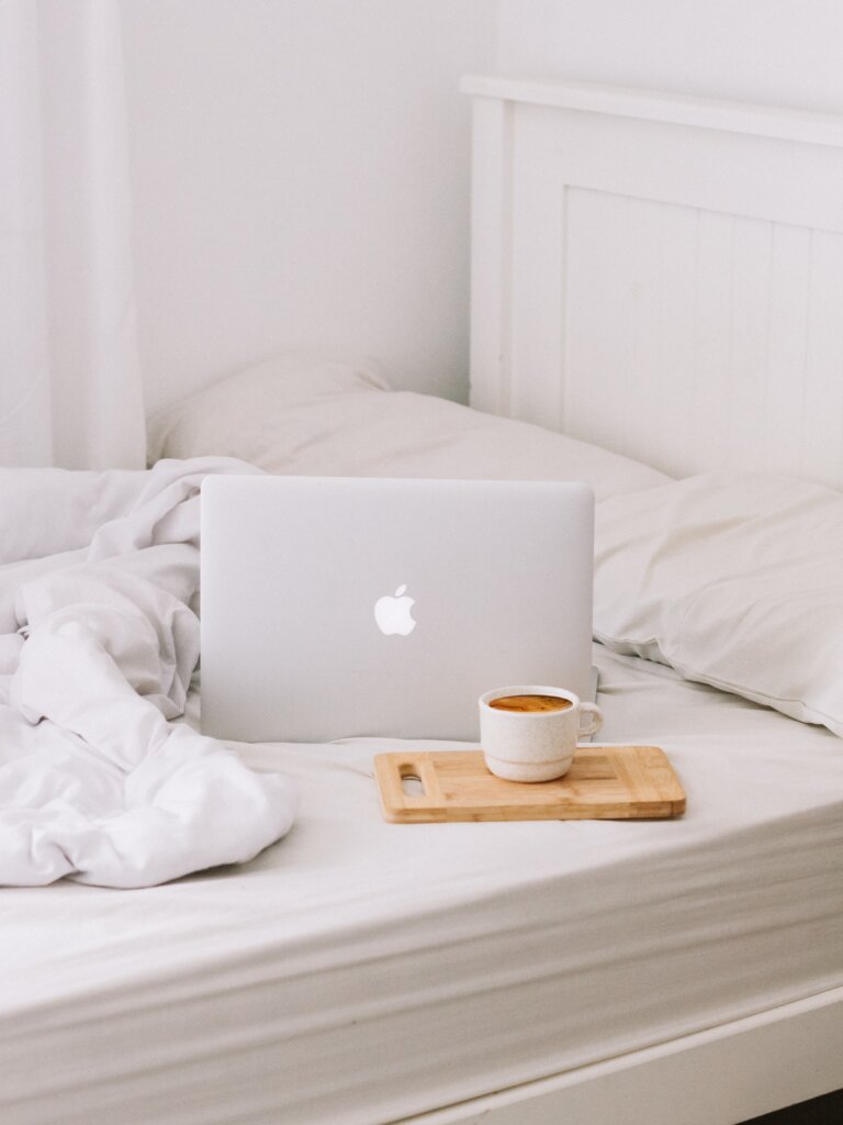 Laptop and tea on a bed