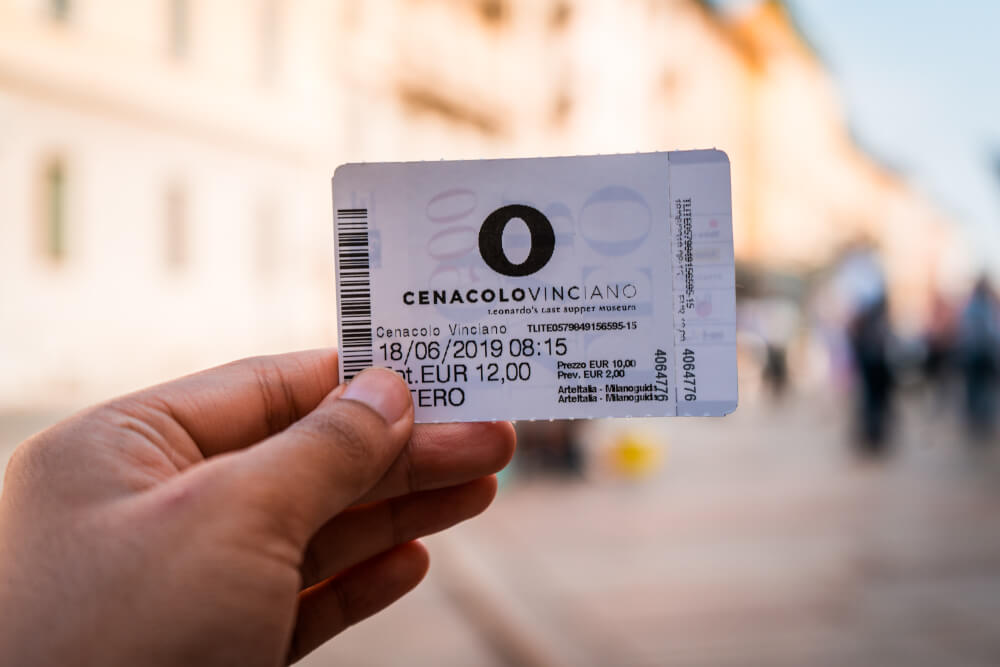 Hand holding a ticket for the Last Supper in Milan, Italy