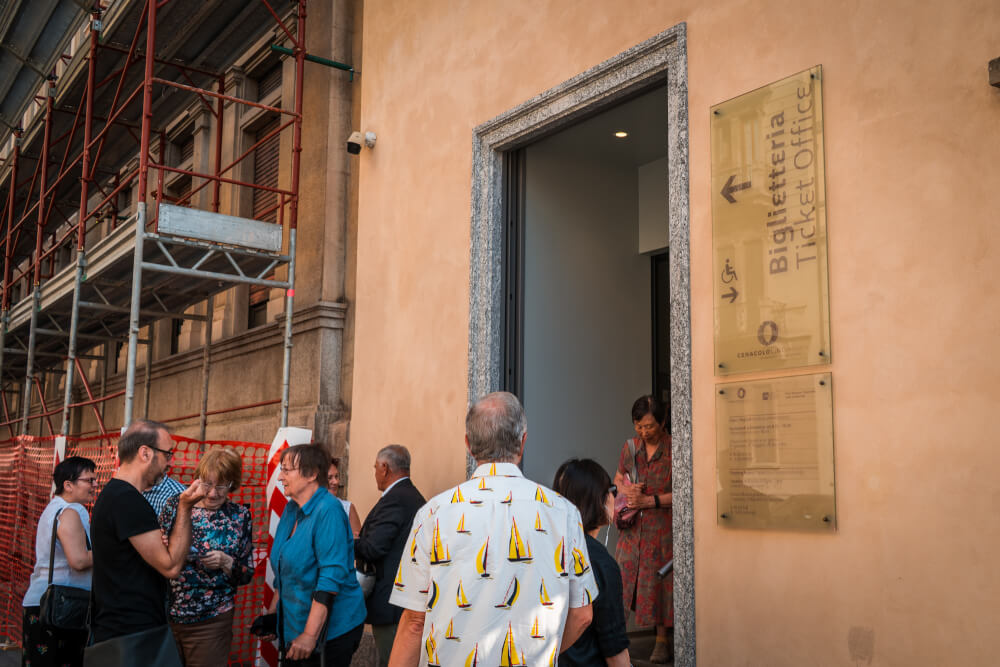 Tourists waiting in line to buy tickets for the Last Supper in Milan