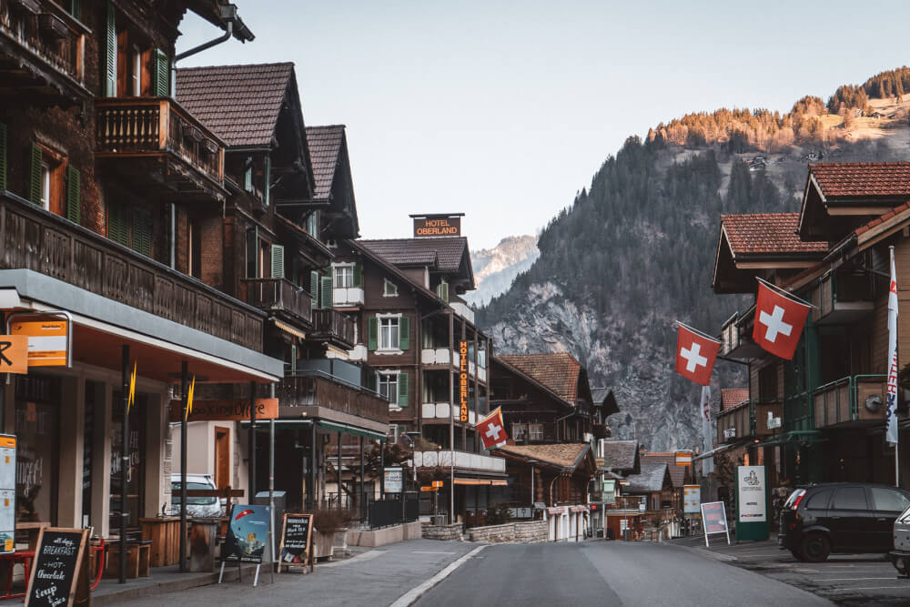 Lauterbrunnen main town view with Swiss flags 