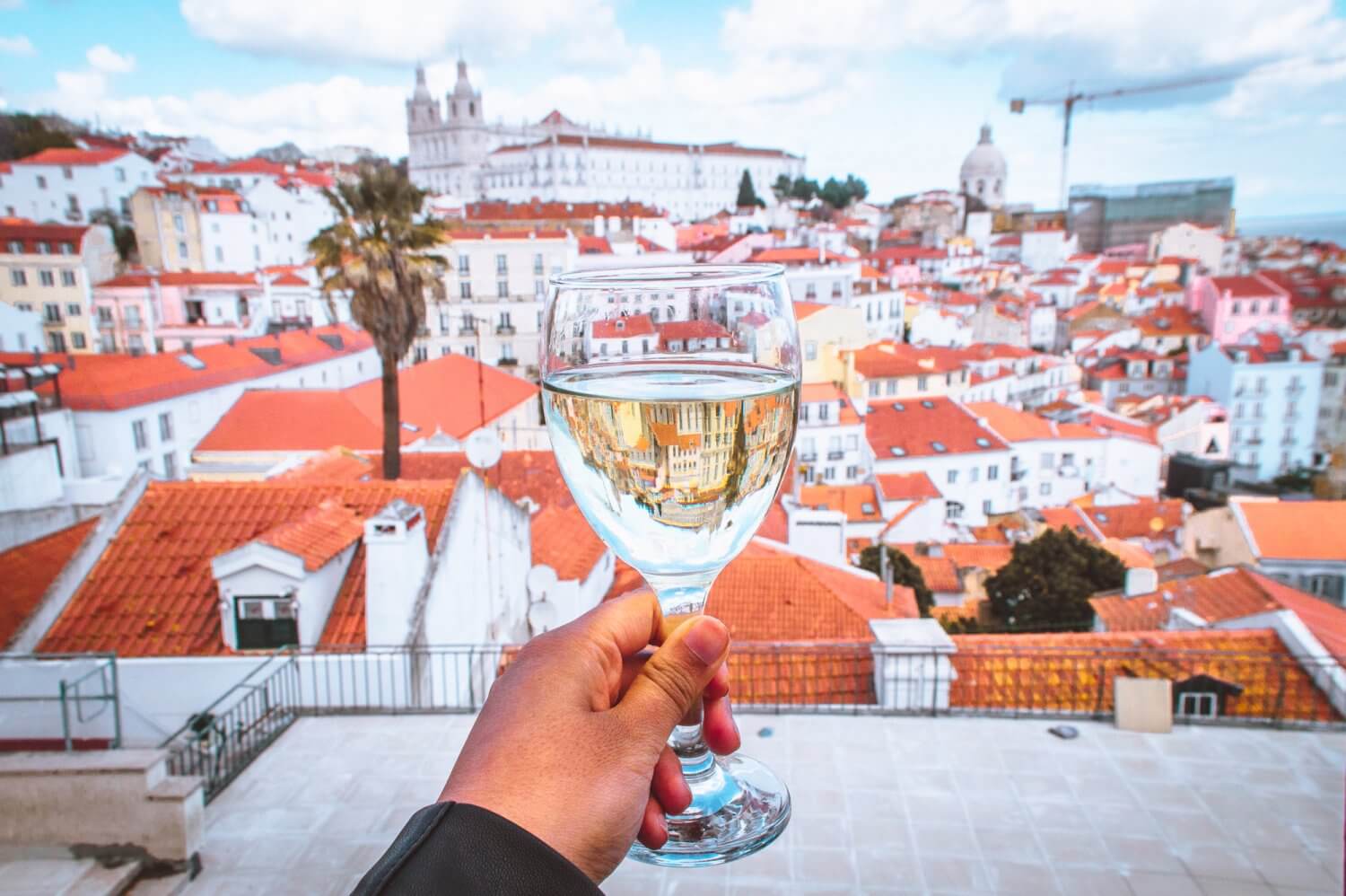 A glass of wine overlooking beautiful Lisbon from Bar Terraco de Santa Luzia, a must when you visit Lisbon.  