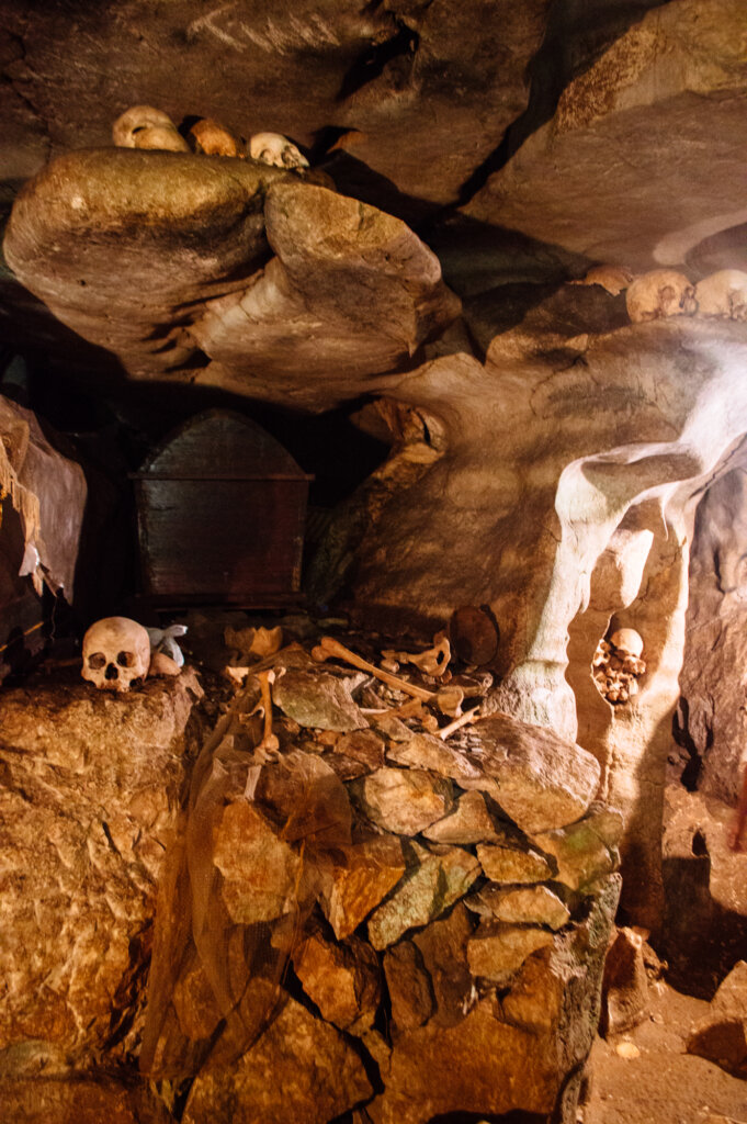 Skulls in a dark cave in Tana Toraja, Indonesia