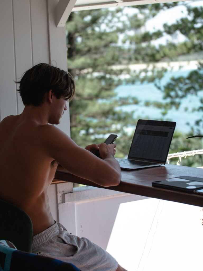 Man on his laptop with a scenic view behind him
