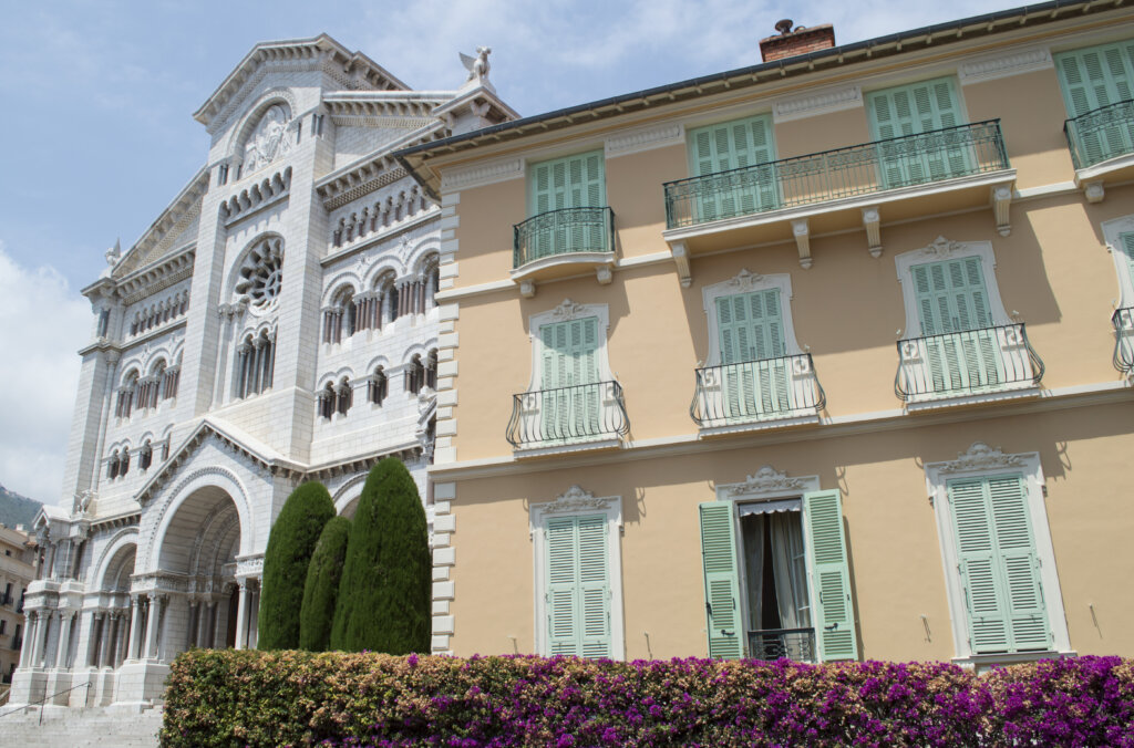 Monaco Cathedral and a peach building with mint shutters