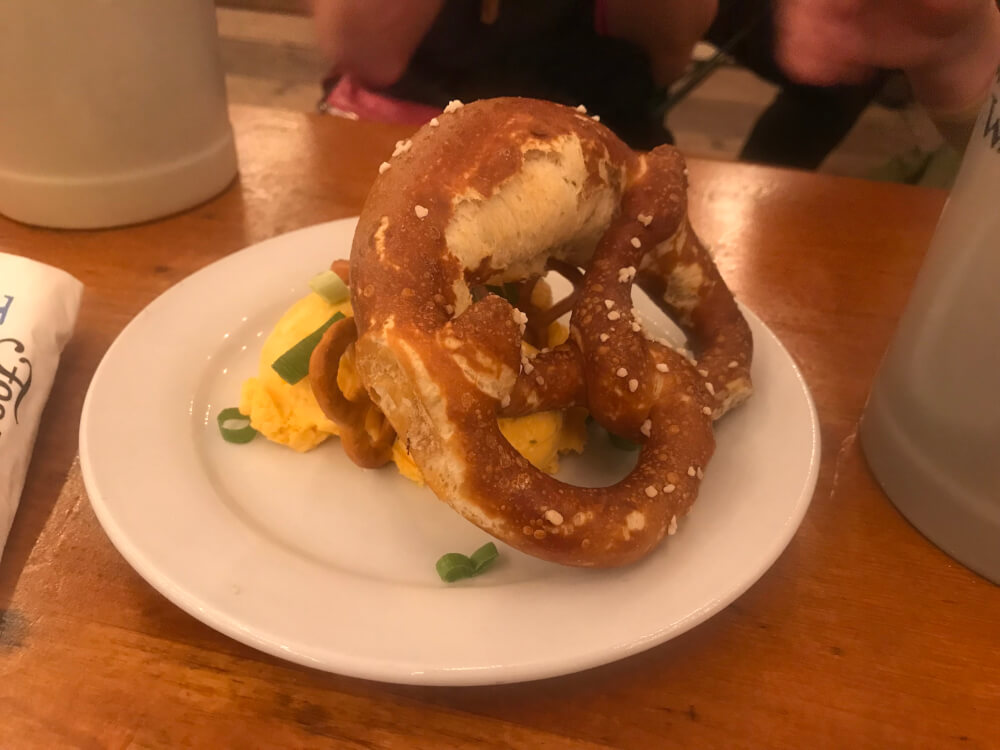 A tasty Obatzda (Bavarian cheese spread) served with a pretzel on top.