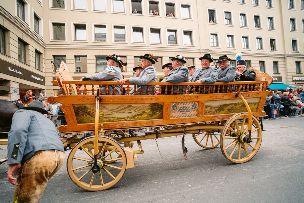 A cart full of Bavarian men in traditional clohes during the annual trachten parade in Munich, Germany