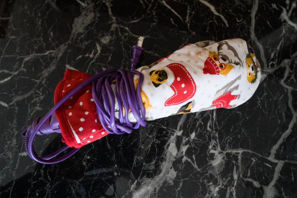 An oven mitt with a hair straightener inside