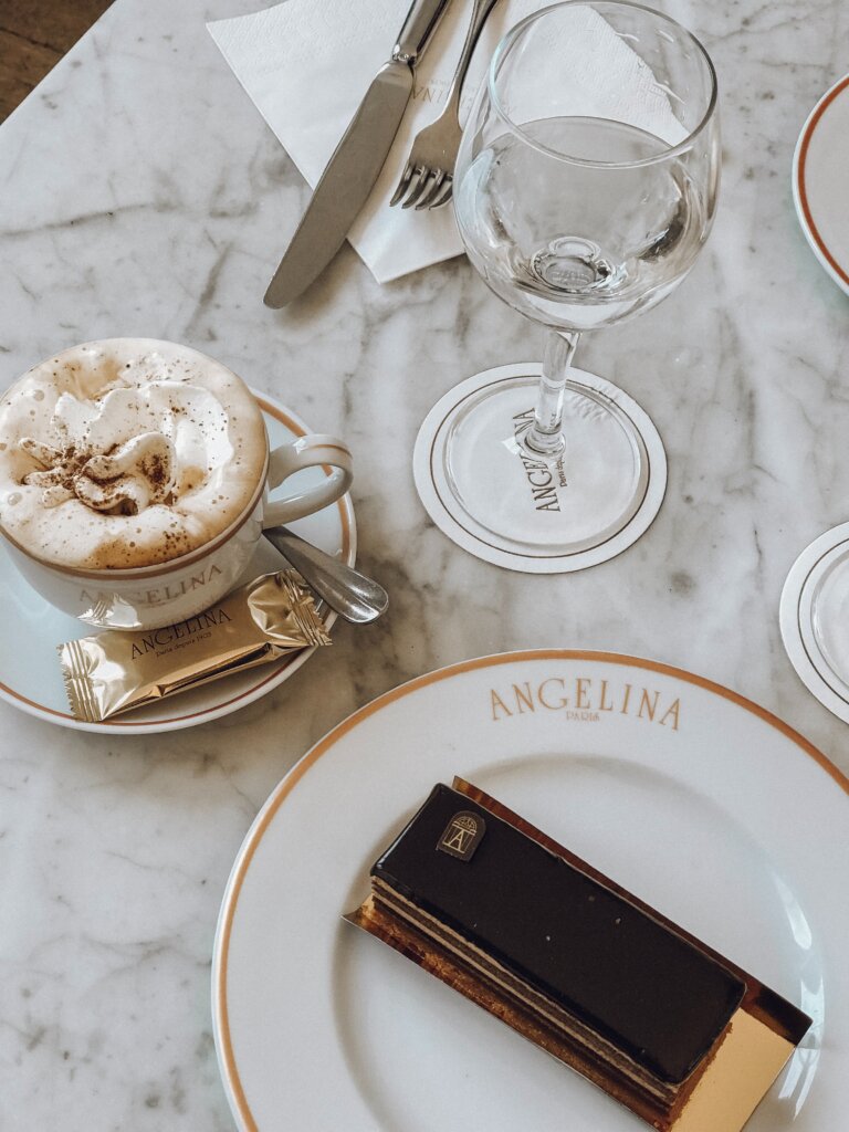 Hot chocolate and pastry on golden plates from Angelina Paris