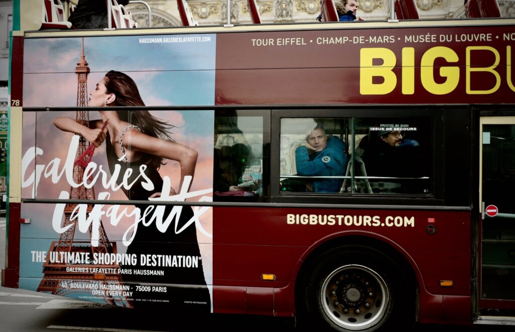 Big bus tour in Paris with Galeries Lafayette ad on the side