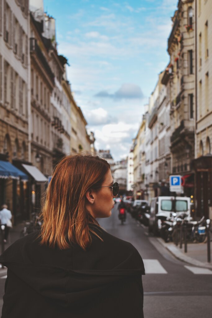 Parisian woman dressed in black crossing the street