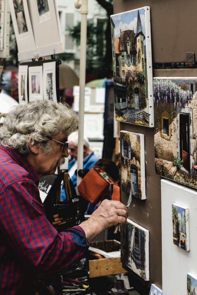 Artist painting in Place du Tertre in Montmartre, Paris, France